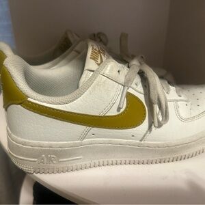 Nike White and Gold Sneakers with Bold Swoosh